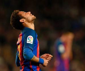 (FILES) This file photo taken on March 19, 2017 shows Barcelona's Brazilian forward Neymar looking skywards during the Spanish league football match FC Barcelona vs Valencia CF at the Camp Nou stadium in Barcelona.Neymar was suspended for three matches will miss the clasico against Real Madrid the football federation announced on April, 11 2017. Neymar was shown the first red card of his Barcelona career for two bookable offences as Barca's title suffered a big blow in a 2-0 defeat at Malaga on Saturday. / AFP PHOTO / LLUIS GENE