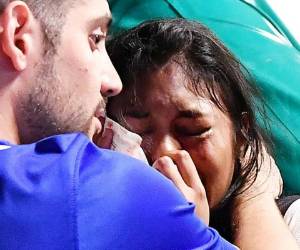An injured Juventus fan cries at the end of the Champions League final soccer match between Juventus and Real Madrid, in Turin's San Carlo Square, Italy, Saturday, June 3, 2017. Juventus fans watching the Champions League final rushed out of a Turin piazza in panic Saturday after witnesses reported hearing a loud sound.(Alessandro Di Marco/ANSA via AP)