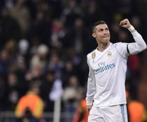 Real Madrid's Portuguese forward Cristiano Ronaldo celebrates a goal during the UEFA Champions League group H football match Real Madrid CF vs Borussia Dortmund at the Santiago Bernabeu stadium in Madrid on December 6, 2017. / AFP PHOTO / JAVIER SORIANO