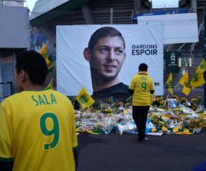 En esta foto del 30 de enero de 2019, hinchas del Nantes rinden un homenaje ante un afiche del futbolista argentino Emiliano Sala, con la leyenda 'mantengamos la esperanza'. La FIFA ha ordenado que el Cardiff pague al Nantes por la transferencia del jugador, fallecido en un accidente aeronáutico. (Foto: AP)