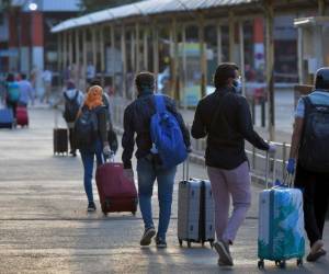 North Indians residing in Bangalore arrive at the Bangalore City Railway Station to board the first train to Delhi following the commencement of train services for members of the public after the government eased the nationwide lockdown as a preventive measure against the spread of COVID-19 coronavirus, in Bangalore on May 12, 2020. (Photo by Manjunath Kiran / AFP)