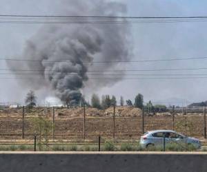 Oleadas de humo de un almacén en el barrio de Renca, Santiago, el 20 de octubre de 2019. Foto AFP