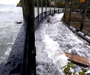 The Hudson River comes over the sea wall along the West Side Promenade in the Battery Park area in New York on October 29, 2012 as New Yorkers prepare for Hurricane Sandy which is supposed to hit the city later tonight. AFP PHOTO / TIMOTHY A. CLARY