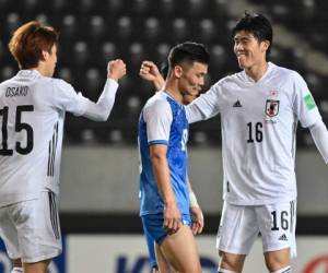 Japan's Yuya Osako (L) and Takehiro Tomiyasu celebrate a goal during the FIFA World Cup Qatar 2022 Asian zone group F qualification football match between Japan and Mongolia at Fuku-ari stadium in Chiba on March 30, 2021. (Photo by CHARLY TRIBALLEAU / AFP)