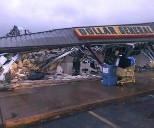 NIXVILLE, SC - APRIL 13: Two men make repairs to a roof damaged by storm on April 13, 2020 near Nixville, South Carolina. A string of storms across the southern United States that began Easter Sunday and continued into today produced multiple tornados resulting in more than 30 deaths and dozens more injuries. Sean Rayford/Getty Images/AFP== FOR NEWSPAPERS, INTERNET, TELCOS & TELEVISION USE ONLY ==