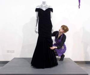(FILES) In this file photo taken on March 15, 2013, a Victor Edelstein midnight blue velvet evening gown, worn by Britain's Princess Diana at the State Dinner at the White House in 1985, when she danced with US actor John Travolta, is pictured at the Kerry Taylor Auction house in south London ahead of its sale. - A midnight blue velvet gown worn by Princess Diana when she danced with actor John Travolta at the White House is being put up for sale, an auction house said on November 18, 2019. Estimated at £250,000-£350,000 (293,000-410,000 euros, $324,000-$454,000), the dress is one of three being sold by Kerry Taylor Auctions on December 9, 2019. (Photo by LEON NEAL / AFP)
