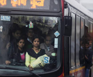 Indian women travel in a bus during heavy downpour in New Delhi on February 5, 2013. In Delhi's crowded coaches, where men easily outnumber women, the sense of hostility and fear is particularly palpable in the wake of the widely-discussed gang-rape and murder of a young student on a moving bus in the city last month. AFP PHOTO/ MANAN VATSYAYANA
