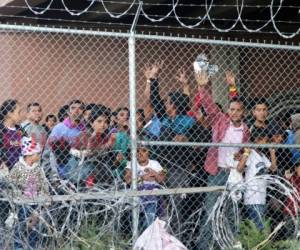 Migrantes centroamericanos esperan por comida en El Paso, Texas, el miércoles 27 de marzo de 2019, dentro de una celda de la Oficina de Aduanas y Protección Fronteriza para procesar el incremento de familias de migrantes y menores sin compañía de un adulto.