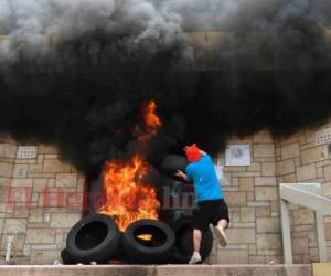 Un grupo de encapuchados provocó este viernes un incendio que causó severos daños a la embajada de Estados Unidos en Honduras, en el marco de una multitudinaria protesta contra reformas a la educación y salud. Foto: Orlando Sierra / Agencia AFP.