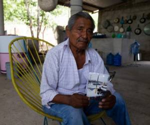 Wilfrido Martínez posa para una fotografía el viernes 26 de junio del 2020 en San Jerónimo Xayacatlan, México. Martínez sostiene en sus manos una imagen de Mauricio, su hijo, que falleció debido al nuevo coronavirus en Nueva York en abril.