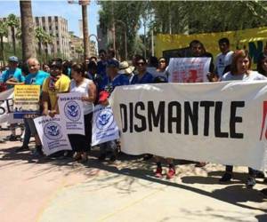Los manifestantes cargan pancartas bajo el intenso calor y protestan en inglés y español. Foto: Twitter Telemundo