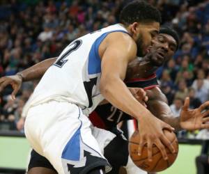Minnesota Timberwolves forward Karl-Anthony Towns (32) controls the ball against Portland Trail Blazers forward Noah Vonleh (21) in the second half of an NBA basketball game, Monday, April 3, 2017, in Minneapolis. The Timberwolves won 110-109. (AP Photo/Stacy Bengs)