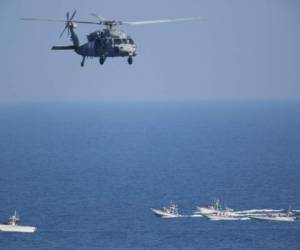 Un helicóptero estadounidense MH-60 Seahawk sobrevuela buques patrulla de la Guardia Nacional de Irán en el Estrecho de Hormuz.(AP Foto/Jon Gambrell, File)