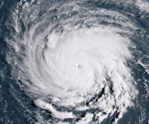 Nick Hobbs, left, and Randy Shaw, right, of Marine Warehouse Center, remove a customer's boat from the water in advance of Hurricane Florence in Wrightsville Beach, N.C., Tuesday, Sept. 11, 2018. Florence exploded into a potentially catastrophic hurricane Monday as it closed in on North and South Carolina, carrying winds up to 140 mph (220 kph) and water that could wreak havoc over a wide stretch of the eastern United States later this week. (AP Photo/Chuck Burton)