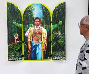 Un hombre observa una pintura inspirada en el cantante Bad Bunny durante la exposición 'Benito 100 x 35' este miércoles, en la Galería I Am Art en San Juan, Puerto Rico.