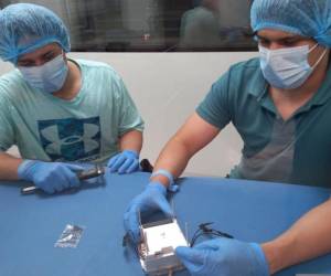 Dos dos integrantes del equipo del proyecto Morazán, ensamblaron el nano satélite en el cuarto limpio de Ciudad Universitaria.