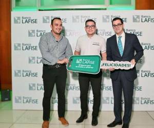 El ganador de la promoción de Banco LAFISE posó junto a su nuevo vehículo, acompañado de los ejecutivos.