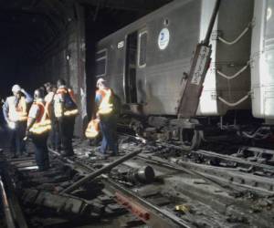 In this photo provided by the Transport Workers Union, Local 100, workers from the New York Metropolitan Transportation Authority examine damaged train tracks, at the scene of a subway derailment, Tuesday, June 27, 2017, in New York. A subway train derailed near a station in the Harlem neighborhood of New York, frightening passengers and resulting in minor injuries as hundreds of people were evacuated from trains along the subway line. (Transport Workers Union, Local 100 via AP)