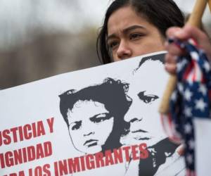 (FILES) This file photo taken on January 8, 2018 shows a young girl as other immigrants and activists protest near the White House to demand that the Department of Homeland Security extend Temporary Protected Status (TPS) for more than 195,000 Salvadorans in Washington, DC.'Give me your tired, your poor, your huddled masses yearning to breathe free': The words on the Statue of Liberty have beckoned comers to the 'Nation of Immigrants' for more than a century. But not with President Donald Trump at the gate. Unlike any US leader in decades, Trump has attacked immigration, slashed legal arrivals, called to expel millions of non-citizens, and invited only wealthy and educated foreigners -- with an evident preference for white Europeans. On January 11,2018, Trump allegedly demanded to know why the US accepted people from 'shithole' places like Haiti and Africa, and suggested the country should instead draw immigrants from Norway. / AFP PHOTO / ANDREW CABALLERO-REYNOLDS