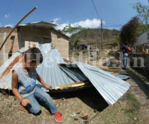 Un menor observa como el techo de su casa quedó en el suelo Fotos: Johny Magallanes. El Heraldo Honduras/ Noticias de Honduras