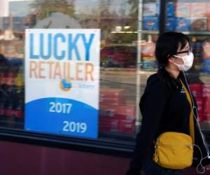 A pedestrian wears a protective mask in Alhambra, Calif., Friday, Jan. 31, 2020. As China grapples with the growing coronavirus outbreak, Chinese people in the Los Angeles area, home to the third-largest Chinese immigrant population in the United States, are encountering a cultural disconnect as they brace for a possible spread of the virus in their adopted homeland. (AP Photo/Damian Dovarganes)