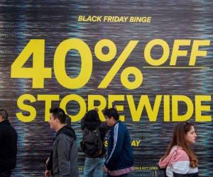 Santa Mónica, California, Estados Unidos: los compradores pasan por una promoción de la tienda durante las ventas del Viernes Negro en Los Ángeles, California, el 29 de noviembre de 2019. La huelga del Viernes Negro se lleva a cabo justo antes de que los líderes mundiales se reúnan en España para la COP25, donde los países discutirán cómo prevenir los impactos catastróficos del cambio climático. / AFP / Mark RALSTON