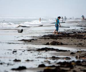 Turistas nacionales se aventuran a adentrarse en el mar picado en la Playa Bagdad, 38 kilómetros al este de Matamoros, estado de Tamaulipas (México).