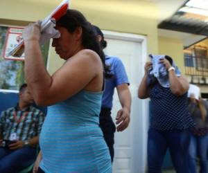 Cubriéndose los rostros algunas de las detenidas al ser trasladadas por miembros de la ATIC (Foto: El Heraldo Honduras/ Noticias de Honduras)