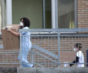 Hospital personnel carry boxes into the hospital of Codogno, near Lodi in Northern Italy, Friday, Feb. 21,2020. Health officials reported the country's first cases of contagion of COVID-19 in people who had not been in China. The hospital in Codogno is one of the hospitals - along with specialized Sacco Hospital in Milan - which is hosting the infected persons and the people that were in contact with them and are being isolated. (AP Photo/Luca Bruno)