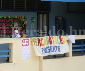Un estudiantes encapuchado observa el campus de la Universidad Nacional Autónoma de Honduras desde la segunda planta del edificio de Ciencias Económicas. Fotos: Mario Urrutia / EL HERALDO.