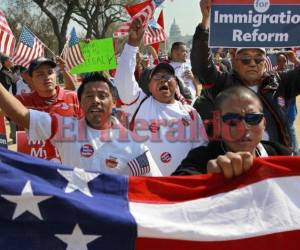 With the Capitol in the background, farm workers from West Palm Beach, Fla., march and chant while attending a rally for immigration reform where tens of thousands of people were expected on the National Mall in Washington, on Sunday, March 21, 2010. (AP Photo/Jacquelyn Martin)