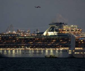 Yokohama, Prefectura de Kanagawa, Japón: se muestra un pequeño bote junto al crucero Diamond Princess con más de 3,000 personas que se encuentra anclado en cuarentena frente al puerto de Yokohama el 4 de febrero de 2020. Foto: AFP
