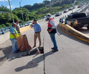 Los daños en la losa del puente exponen las varillas bajo el concreto.