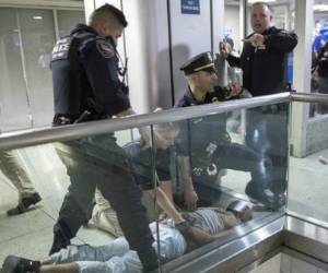 Paramedics and ultra-Orthodox Jewish men stand next to covered bodies after dozens of people were killed and others injured after a grandstand collapsed in Meron, Israel, where tens of thousands of people were gathered to celebrate the festival of Lag Ba'omer at the site in northern Israel early on April 30, 2021. - Dozens of people were killed in a stampede at a Jewish pilgrimage site in the north of Israel on early on April 30, rescue services said. Tens of thousands of Jews were participating in the annual pilgrimage on Thursday, for the feast of Lag BaOmer. But after midnight, a grandstand collapsed, triggering scenes of panic. (Photo by DAVID COHEN/JINI PIX / JINI PIX / AFP) / Israel OUT