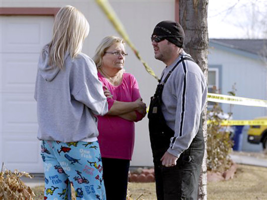 Neighborhood residents talk amid crime-scene tape at the scene of an apparent murder-suicide, which officials say left four dead inside a home, according to officials, in Longmont, Colo., Tuesday Dec. 18, 2012. Weld County sheriff’s spokesman Tim Schwartz says dispatchers heard the woman who called 911 scream “No, no, no,” and then they heard a gunshot. Schwartz says a man grabbed the phone and said he was going to kill himself, and dispatchers heard another shot. (AP Photo/Brennan Linsley)