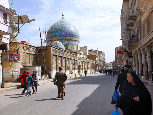 In this March 8, 2013 photo, pedestrians walk down Rashid Street in Baghdad, Iraq. In Baghdad, life goes on much as it has since the Ottoman sultan ruled these parts. Yet the legacy of a war that began a decade ago remains very much a part of life here too. (AP Photo/Hadi Mizban)