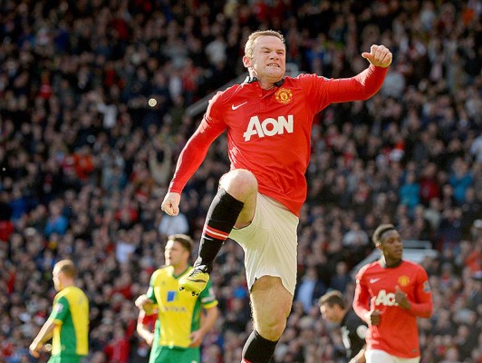 Manchester United's English striker Wayne Rooney celebrates after scoring a penalty during the English Premier League football match between Manchester United and Norwich City at Old Trafford in Manchester, northwest England, on April 26, 2014. AFP PHOTO/ANDREW YATESRESTRICTED TO EDITORIAL USE. NO USE WITH UNAUTHORIZED AUDIO, VIDEO, DATA, FIXTURE LISTS, CLUB/LEAGUE LOGOS OR “LIVE” SERVICES. ONLINE IN-MATCH USE LIMITED TO 45 IMAGES, NO VIDEO EMULATION. NO USE IN BETTING, GAMES OR SINGLE CLUB/LEAGUE/PLAYER PUBLICATIONS