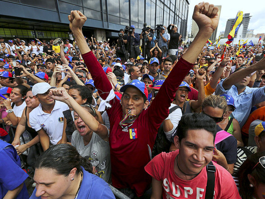 Supporters of opposition leader Henrique Capriles cheer as he speaks at a protest rally against Venezuela's President Nicolas Maduro in Caracas, Venezuela, Saturday, Nov. 23, 2013. The nationwide day of protests was the first called by Capriles since he lost by a thin margin to Maduro in April’s snap election following the death of Hugo Chavez. (AP Photo/Fernando Llano)