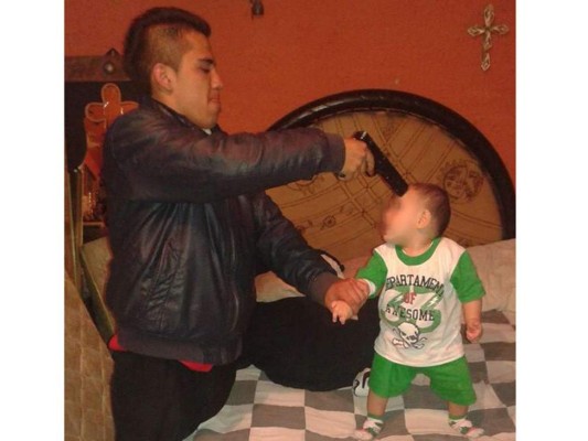 Apunta con arma a bebé