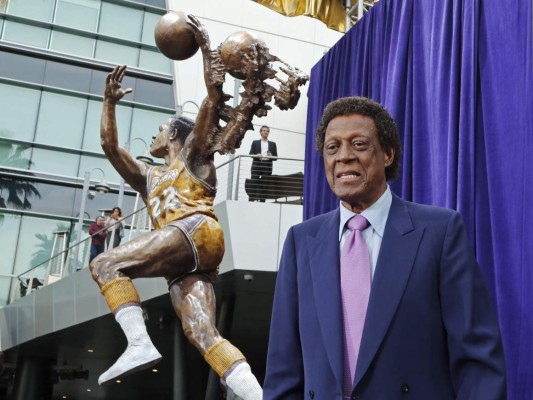 Elgin Baylor posa frente a una estatua en su honor frente a la arena Staples Center de Los Ángeles, el viernes 6 de abril de 2018. Foto: AP