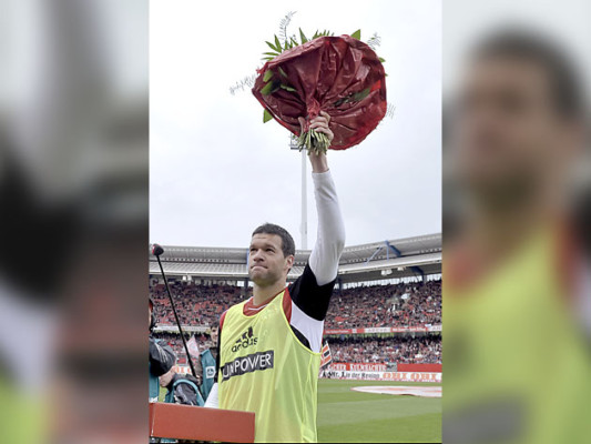 FILES - Picture taken on May 5, 2012 shows Leverkusen's midfielder Michael Ballack receives flowers before his last game, the German first division Bundesliga football match between 1. FC Nuernberg and Bayer 04 Leverkusen in Nuremberg, southern Germany. Ex-Germany captain Michael Ballack announced on Octopber 2, 2012 he has retired from professional football with the former Chelsea star currently without a club. AFP PHOTO / GUENTER SCHIFFMANN