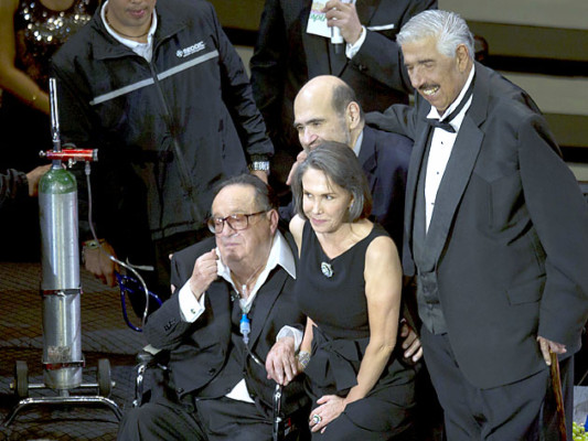 Mexican comedian Roberto Gomez Bolanos, popularly known as Chespirito, left, attends an event in his honor at the National Auditorium in Mexico City, Wednesday Feb. 29, 2012. The Chavo del Ocho show, created by Gomez Bolanos, is popular throughout Latin America and is still being aired in reruns in Mexico. From right, Ruben Aguirre, who played the character of 'El senor Jirafales' in the show, Edgar Vivar who played the character of 'El senor Barriga' and Florinda Meza, Gomez Bolanos' wife, who played the character of 'Dona Florinda.' (AP Photo/Eduardo Verdugo)