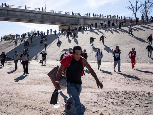 Fotos del momento en el que migrantes de la caravana saltaron valla fronteriza de Estados Unidos, pero fueron detenidos con gases lacrimógenos