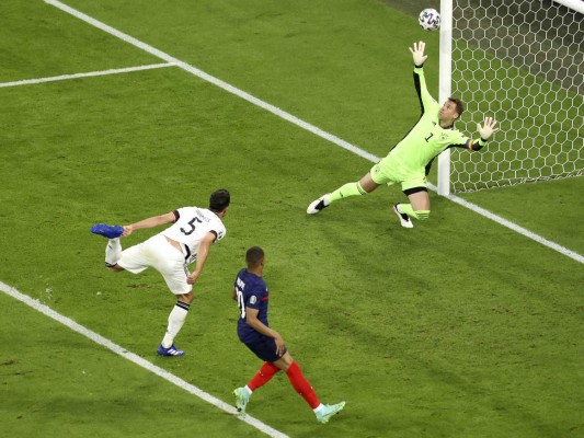 El zaguero alemán Mats Hummels (izquierda) anota un autogol en el partido de la Euro 2020 contra Francia, el martes 15 de junio de 2021, en Múnich. (AP Foto/Alexander Hassenstein, Pool)