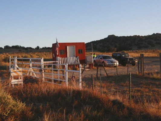 The entrance to a film set where police say actor Alec Baldwin fired a prop gun, killing a cinematographer, is seen outside Santa Fe, New Mexico, Friday, Oct. 22, 2021. The Bonanza Creek Ranch film set has permanent structures for background used in Westerns, including 'Rust,' the film Baldwin was working on when the prop gun discharged. (AP Photo/Cedar Attanasio)