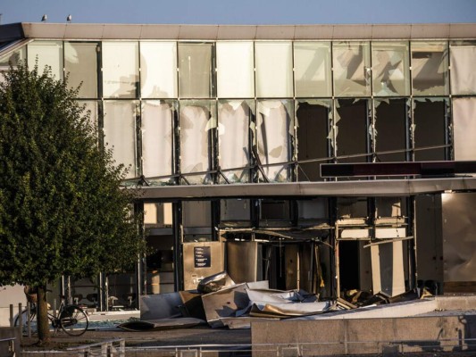 En la imagen, la entrada de la Autoridad Fiscal Danesa, dañada por una explosión delante del edificio, en Copenhague. Foto: AP.