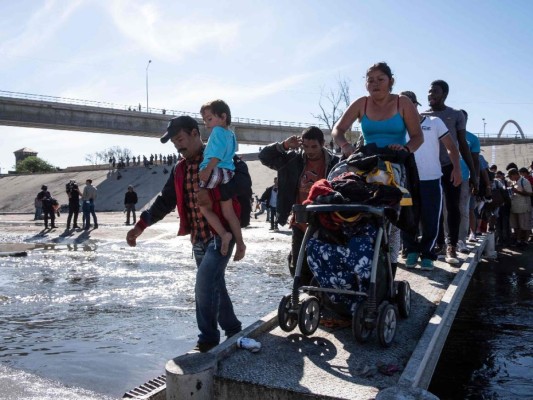 Fotos del momento en el que migrantes de la caravana saltaron valla fronteriza de Estados Unidos, pero fueron detenidos con gases lacrimógenos