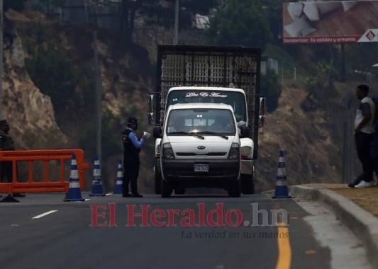 Un policía revisa la documentación de un vehículo que ingresaba a Tegucigalpa el domingo 26 de abril. La circulación está prohibida en Honduras, salvo para los empleados de las labores esenciales durante la emergencia contra el Covid-19. Foto: Emilio Flores / EL HERALDO.