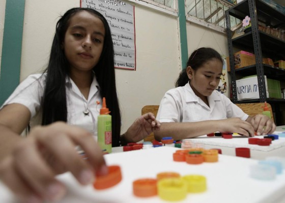 Estudiantes elaboran cuadros decorativos con tapones de refrescos
