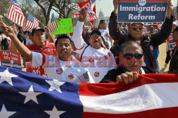 With the Capitol in the background, farm workers from West Palm Beach, Fla., march and chant while attending a rally for immigration reform where tens of thousands of people were expected on the National Mall in Washington, on Sunday, March 21, 2010. (AP Photo/Jacquelyn Martin)